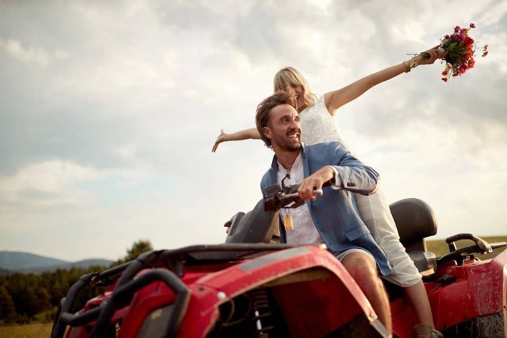 man and woman riding an atv together